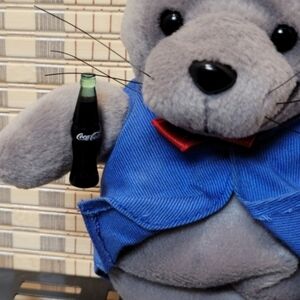 Vintage Coca Cola plush toy Seal dressed in a Delivery Outfit